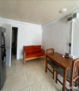 a living room with a red couch and a table at Thrillers for the guest that works remote in True Blue