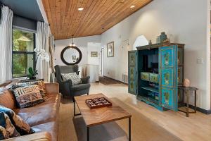 a living room with a couch and a tv at Camp Ciyole in Guerneville