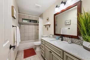 a bathroom with a sink and a toilet and a mirror at Camp Ciyole in Guerneville +46 photos