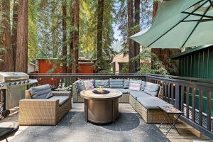 a patio with a table and chairs and a grill at Camp Ciyole in Guerneville