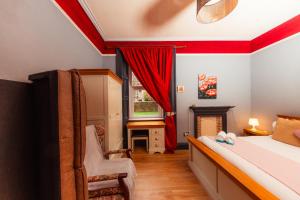 a bedroom with a bed and a chair and a window at Warm, Cozy&Relaxed Apartment by Holyrood Palace in Edinburgh