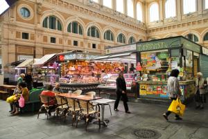 a group of people walking around a market in a building at Acquaviva Apartments in Livorno