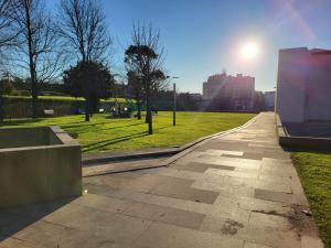 a walkway in a park with the sun in the background at Trilhos do Diabo, T1 in Vila do Conde