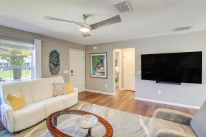 a living room with a white couch and a flat screen tv at Renovated Home in The Villages with Lanai, Golf Cart in The Villages