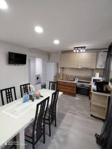 a kitchen with a table and chairs in a room at Apartament in centrul istoric in Baia Mare
