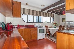 a kitchen with a table and a white stove top oven at Prime Location Handy CBD& Restaurants in Christchurch