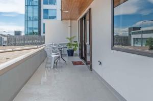 a balcony with a table and chairs on a building at Prime Location Handy CBD& Restaurants in Christchurch