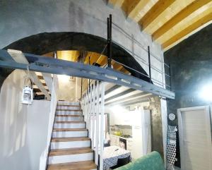 a spiral staircase in a room with a stair case at Casa vacanza in lipari ,PIANO PIANO in Lipari