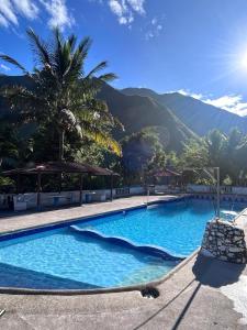 a large blue swimming pool with mountains in the background at HOSTERIA SAN GERONIMO in Ibarra
