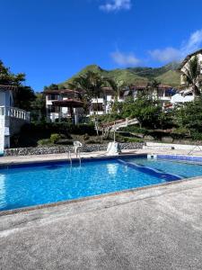 a swimming pool with blue water in front of a house at HOSTERIA SAN GERONIMO in Ibarra