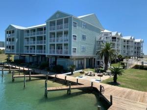 a large building next to a body of water at Jubilee Landing 107 in Orange Beach
