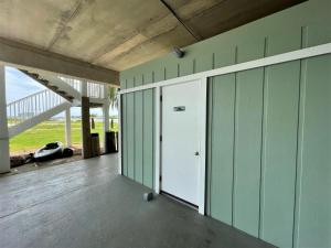 a garage with green walls and a white door at Jubilee Landing 107 in Orange Beach
