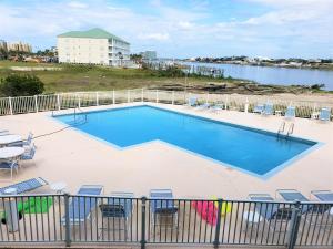 a swimming pool on a balcony with a view of the water at Jubilee Landing 107 in Orange Beach