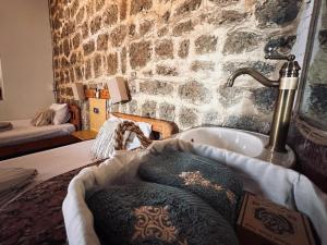 a bathroom with a sink and a stone wall at El Quseir Hotel in Quseir