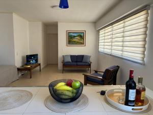 a living room with a bowl of fruit on a table at Cómodo apartamento Vacacional en Margarita 