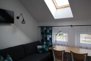 a living room with a couch and a table at Apartamenty Słoneczny Wieczór in Braniewo