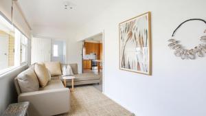 a living room with a couch and a chair at Bungalow 21 in Callala Beach