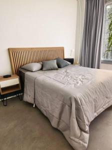 a bedroom with a bed with a blanket and a window at Departamento tipo CASA - Palermo in Buenos Aires