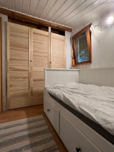 a bedroom with a bed and some wooden cabinets at Waldfee in Panketal