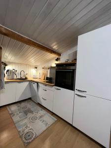 a kitchen with white cabinets and a white refrigerator at Waldfee in Panketal