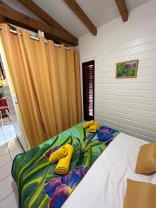 Postel nebo postele na pokoji v ubytování L'escale Tropicale