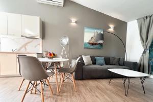 a living room with a couch and a table at Adriatic Resort Apartments in Dubrovnik