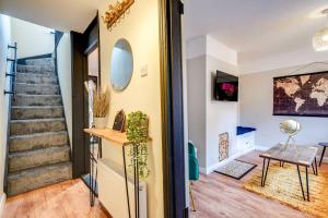 a hallway of a home with stairs and a mirror at Stylish Victorian house, close to City Centre in Colchester