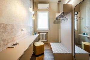 a bathroom with a bench and a window at Urban Cottage [Free Parking - Private Garden] in Bologna