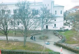 two people walking down a sidewalk in front of a building at Quad Room In Keplerplatz in Vienna