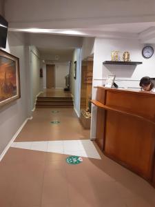 a hallway in a building with a clock on the floor at Hotel Quitor in Calama
