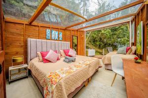 a bedroom with two beds in a room with windows at TERRAMAGA glamping in San Francisco