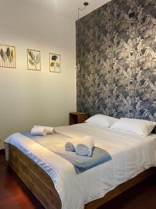 a bedroom with a large bed with towels on it at civico settee in Rome