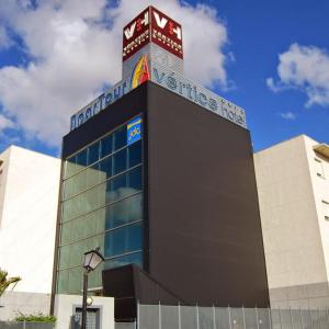 a building with a sign on the top of it at ApartHome® in Bormujos