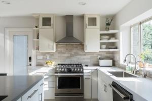 a kitchen with white cabinets and a stove top oven at Spacious and Bright 5-Bedroom Oasis Pool and Yard in La Mesa