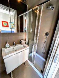 a bathroom with a shower with a sink and a shower at -Penthouse con Terrazza Panoramica -Free Parking- in Carrara