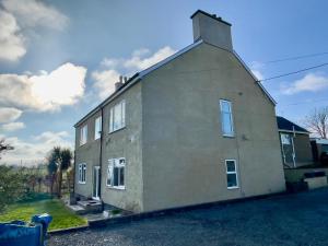 a house that is sitting on the street at Clydfan in Holyhead