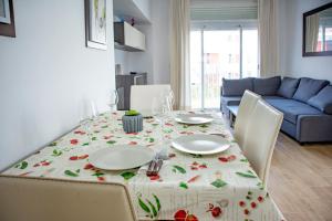 a dining room table with a white table cloth with flowers at Apartamento "Casa el Sargazo" en Vera Playa con Piscina, Solarium, Wifi y Parking Gratis in Vera +27 photos