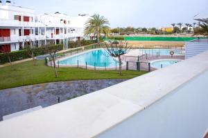 a view of a swimming pool at a resort at Apartamento "Casa el Sargazo" en Vera Playa con Piscina, Solarium, Wifi y Parking Gratis in Vera
