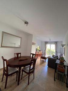 a living room with a table and chairs and a couch at Jerez, zona norte, Cadiz, España in Jerez de la Frontera