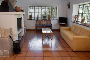 a living room with a couch and a fireplace at Rincon de Sueños in Tilcara