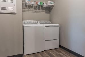 a kitchen with a white stove and a refrigerator at Spacious 2BR Suite Plus Patio Near Iowa State in Ames
