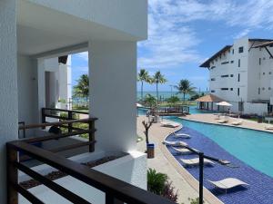 a view of the pool from the balcony of a hotel at Maui Beach Residence in Tamandaré