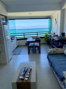 a living room with a view of the ocean at Maui Beach Residence in Tamandaré +175 photos