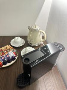 a coffee maker sitting on top of a table at Gmaison in Milan