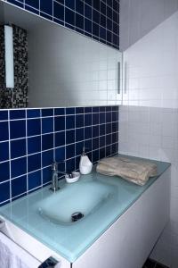 a bathroom with a sink with blue tiles on the wall at WANKAETXEA - Vitoria Gasteiz in Arechavaleta