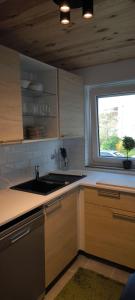 a kitchen with a sink and a window at Fresh renovated. 3 Róoms. Central Leonberg. Private parking spot. in Leonberg