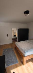 a bedroom with a bed and a rug at Fresh renovated. 3 Róoms. Central Leonberg. Private parking spot. in Leonberg