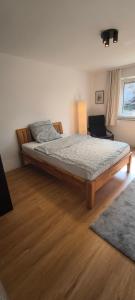 a bedroom with a large bed in a room at Fresh renovated. 3 Róoms. Central Leonberg. Private parking spot. in Leonberg