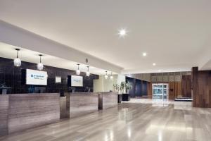 a lobby of a hotel with a reception desk at Wyndham Monterrey Ambassador Centro in Monterrey
