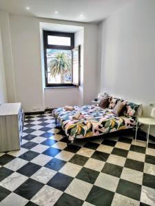 a bedroom with a bed and a checkered floor at - The Marble Theater- [Carrara Centro] in Carrara